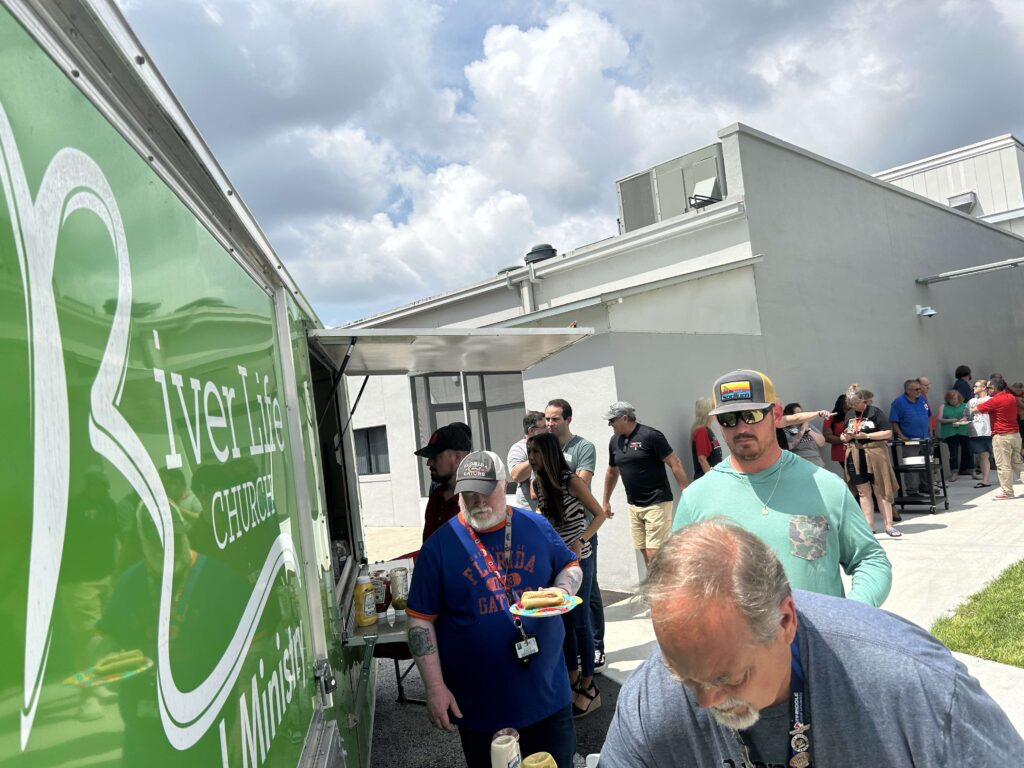 A large line of teachers and staff wait patiently for their free lunch provided by River Life Church