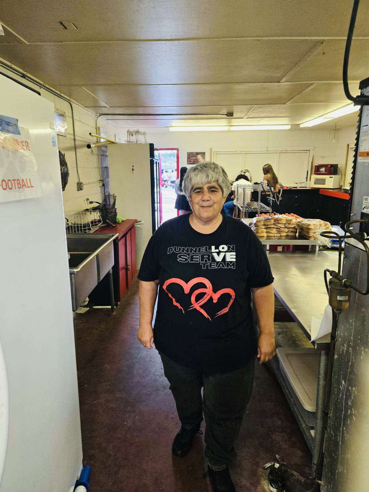 Serve Team Member Vivian stands in the concession stand