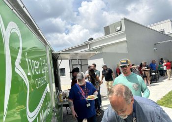 A large line of teachers and staff wait patiently for their free lunch provided by River Life Church