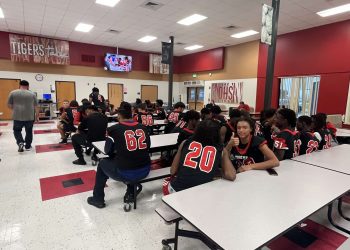 DHS Football players sit patiently waiting to be fed