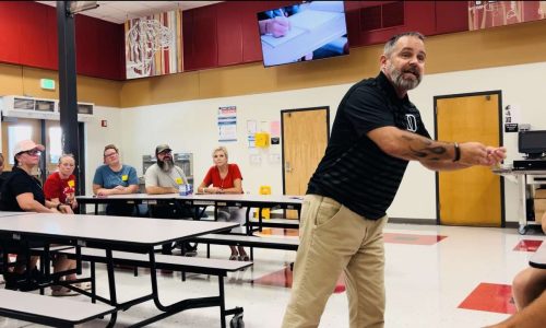 Pastor Tom gives a deviotional before an away game to the dunnellon highschool tigers august 2024